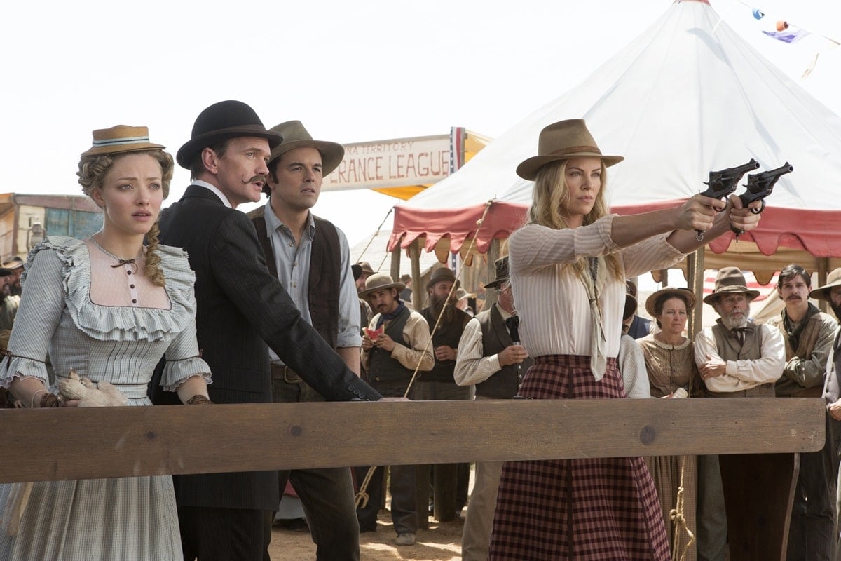 Seth MacFarlane as Albert Stark, Charlize Theron as Anna Barnes-Leatherwood, Amanda Seyfried as Louise, and Neil Patrick Harris as Foy in the 2014 American Western black comedy film A Million Ways to Die in the West