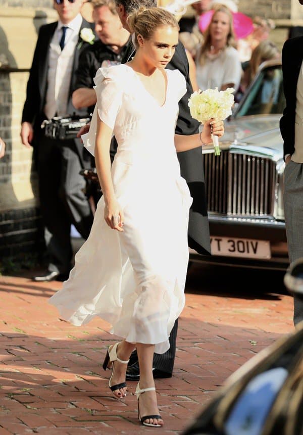 Cara Delevingne in a white Chanel dress outside St. Paul's Church