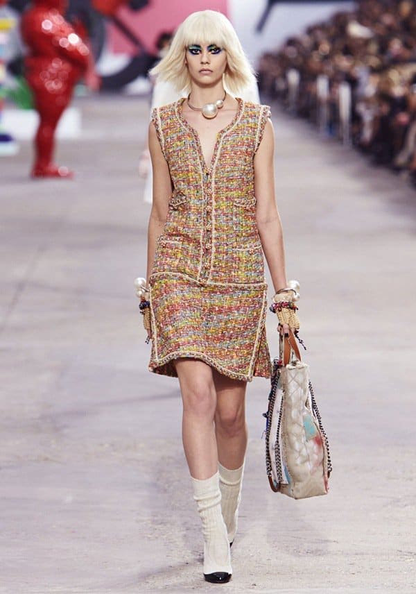 Model carrying a Chanel Graffiti tote handbag