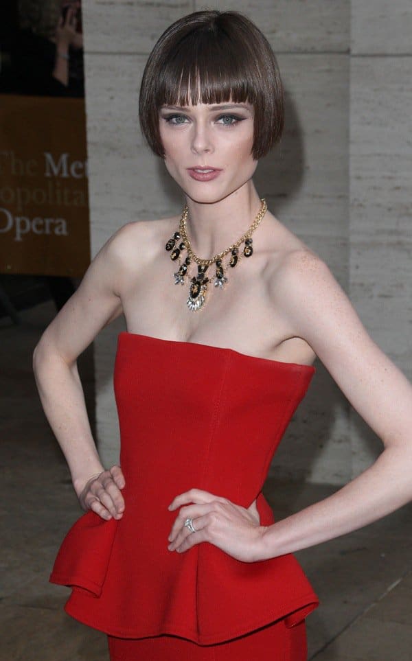 Coco Rocha shows how to wear a big necklace with a red peplum dress