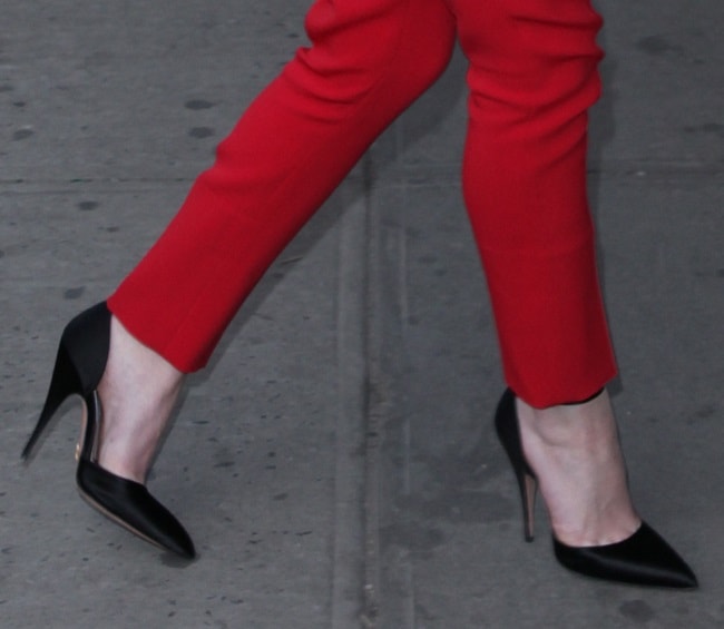 Dakota Fanning perfectly pairs her red jumpsuit with black shoes