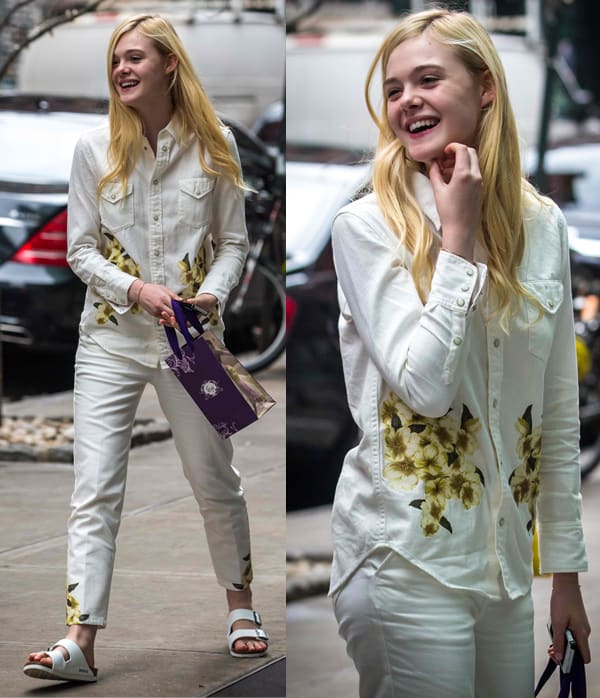 Captured on May 15, 2014, Elle Fanning radiates youthful elegance as she returns to her New York hotel, dressed in a pristine white floral shirt and matching trousers