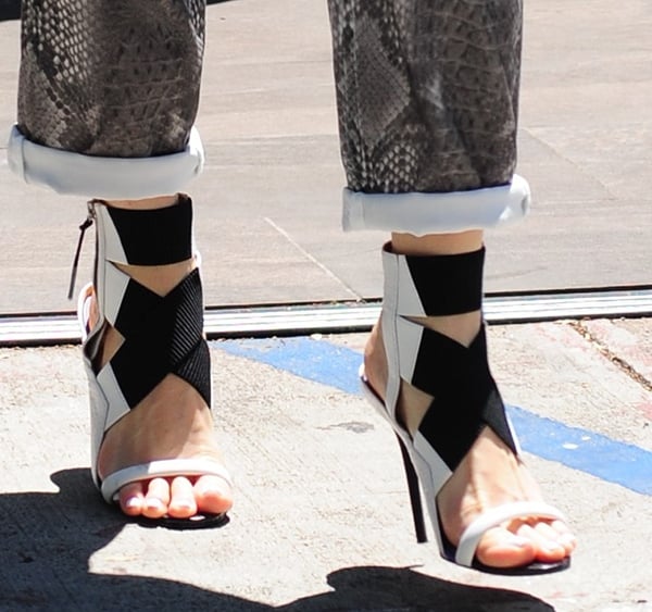 Gwen Stefani rocks monochrome sandals with elastic crossover straps and snake-embossed trims
