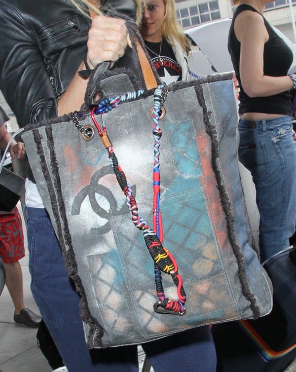 Gwyneth Paltrow carrying the Chanel Colorama Graffiti tote, a bold watercolor-inspired canvas bag from the brand's edgy Spring/Summer 2014 collection