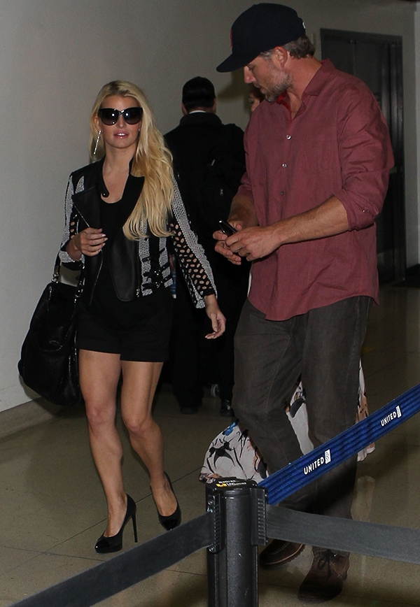 Jessica Simpson and Eric Johnson arriving at LAX, with Jessica stunning in a black-and-white Yigal Azrouël jacket, black shorts, and high heel pumps