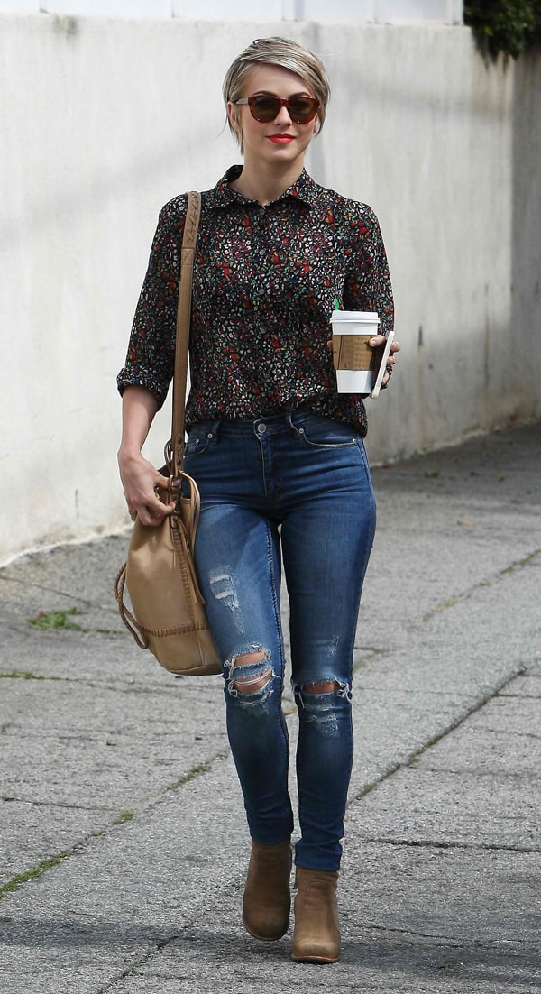 Julianne Hough demonstrates age-appropriate elegance with a printed button-down shirt and distressed jeans, complemented by a bucket bag and ankle boots for a balanced, stylish look