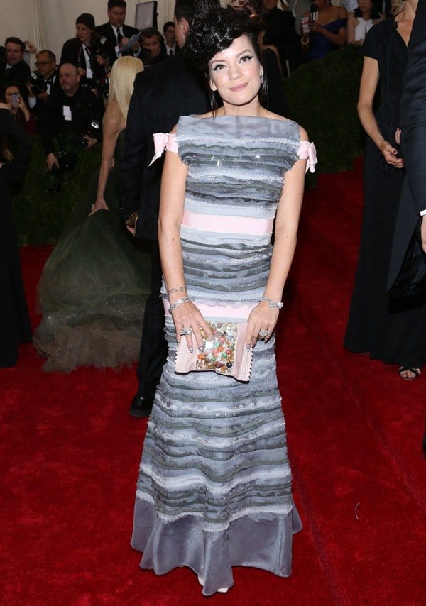 Lily Allen adds a touch of whimsy to her Chanel Couture gown with a baby pink candy-themed clutch adorned with colorful embellishments