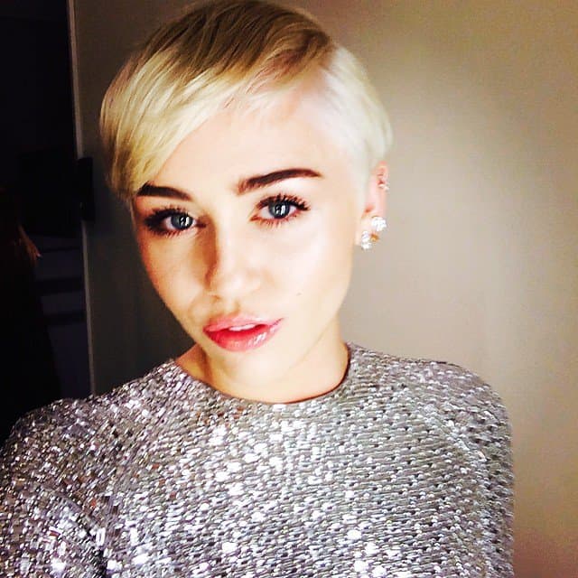 Miley Cyrus shines in a sparkling silver dress and chic short blonde hair at the 2014 World Music Awards