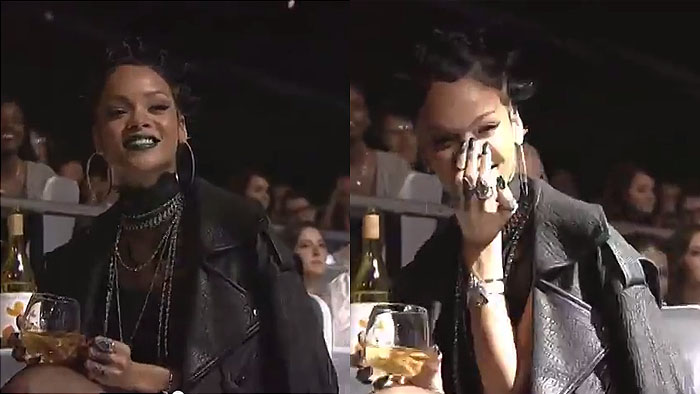 Rihanna covers her mouth and giggles during Ariana Grande's iHeartRadio performance