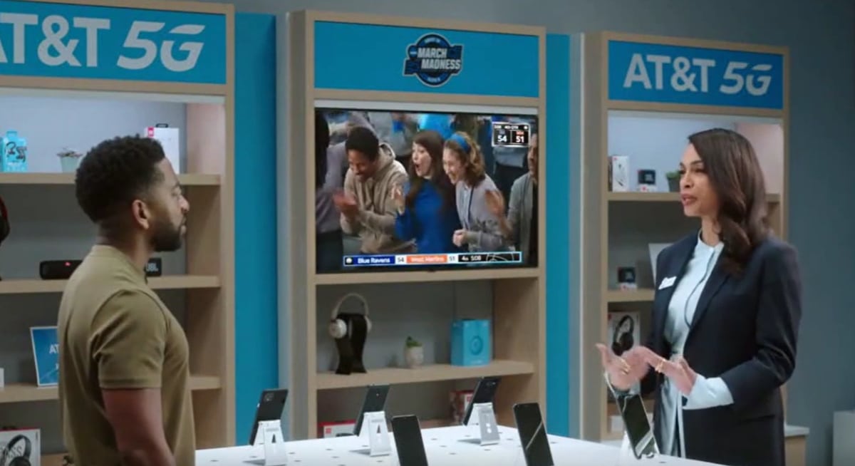 Milana Vayntrub, known for playing Lily Adams in AT&T television commercials, can be seen in the background as Rosario Covers interacts with a customer