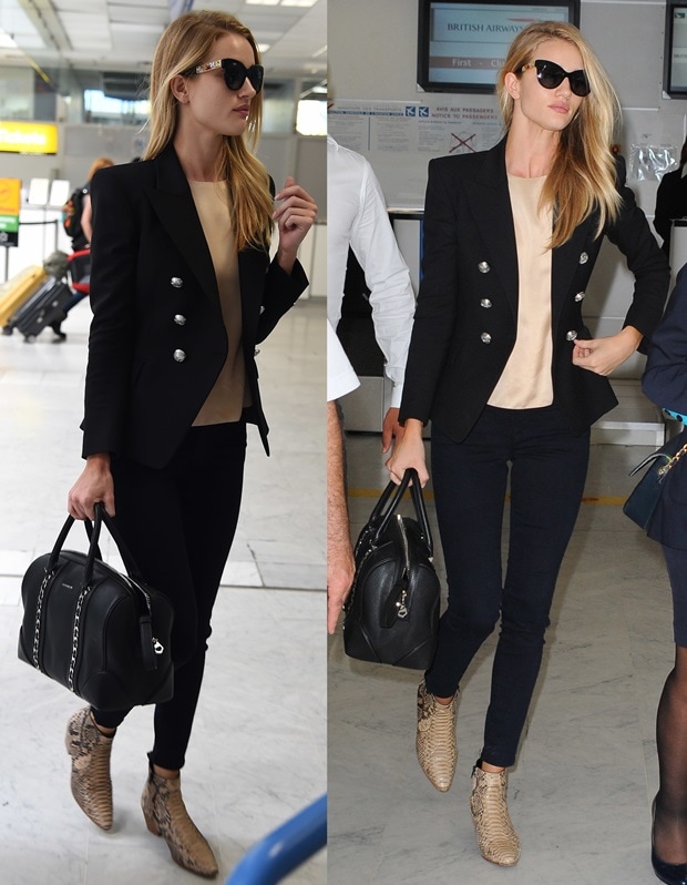 Rosie Huntington-Whiteley demonstrates effortless airport chic by pairing a tailored Balmain blazer with skinny jeans, Saint Laurent python boots, and a Givenchy duffel bag—perfect for achieving a polished travel look that balances style and comfort