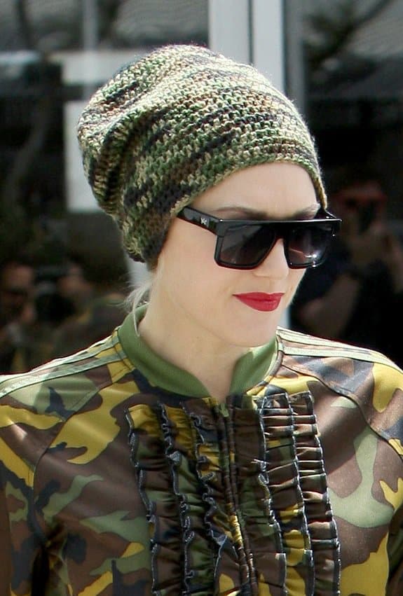 Gwen Stefani sports an Adidas Jeremy Scott camo jacket with ruffle detailing and a matching camo-patterned beanie