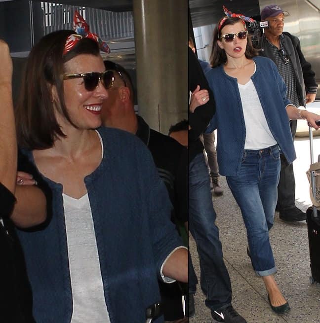 Milla Jovovich looks effortlessly chic at LAX, pairing her blue textured jacket with boyfriend jeans, a white tee, and a colorful headscarf
