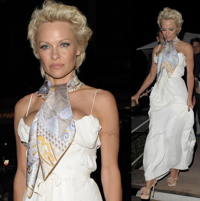 Pamela Anderson wearing a long white dress with a neckerchief