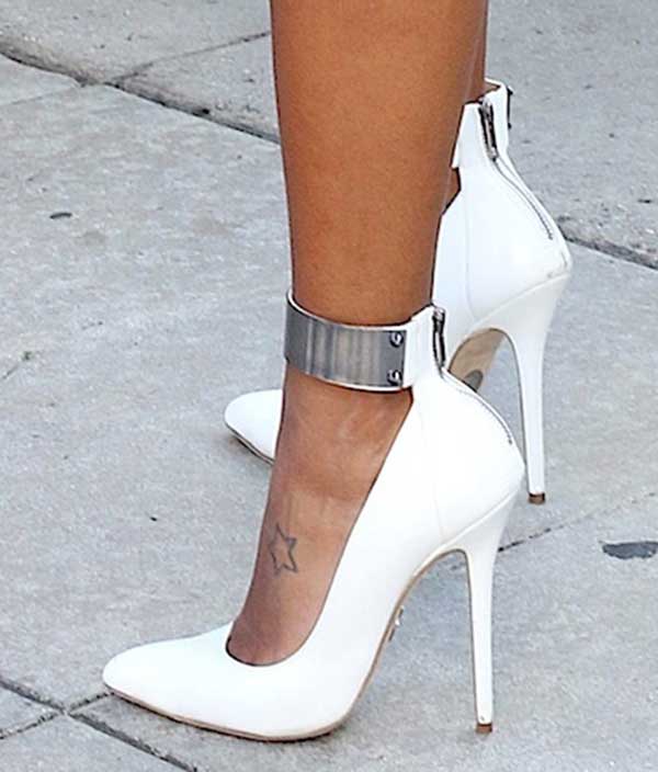 Angela Simmons is wearing Olcay Gulsen pumps that showcase her foot tattoo