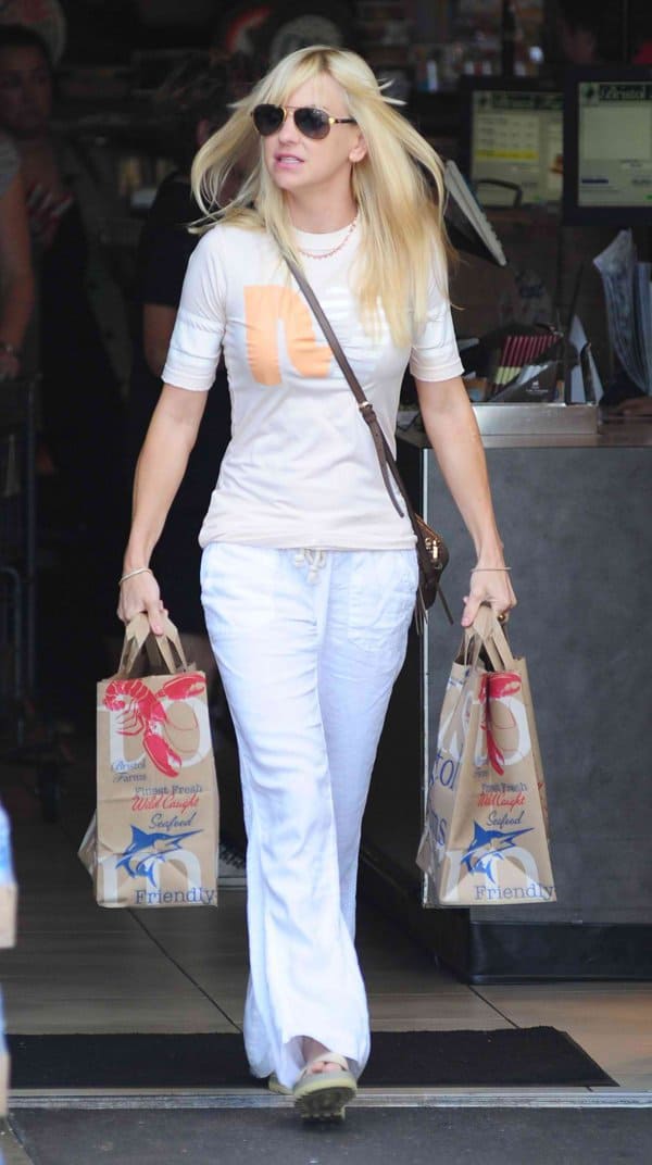 Anna Faris wearing white wide-legged trousers