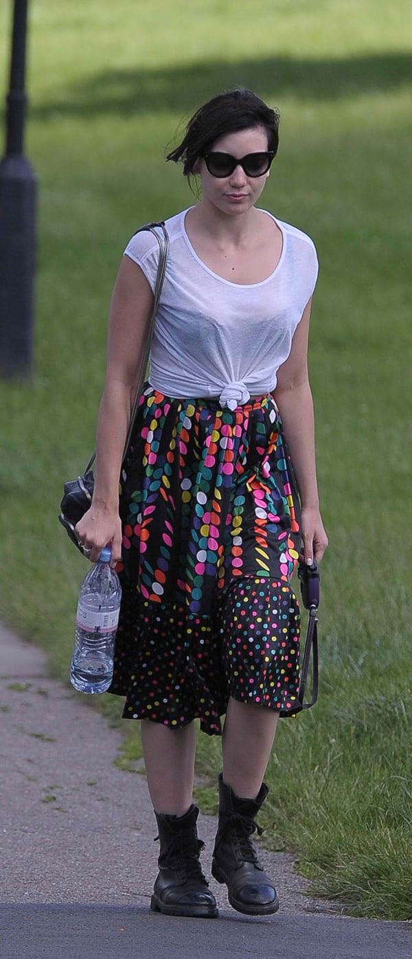 Full view of Daisy Lowe in a retro polka-dotted skirt and heavy boots, an unexpected combination for a summer day out