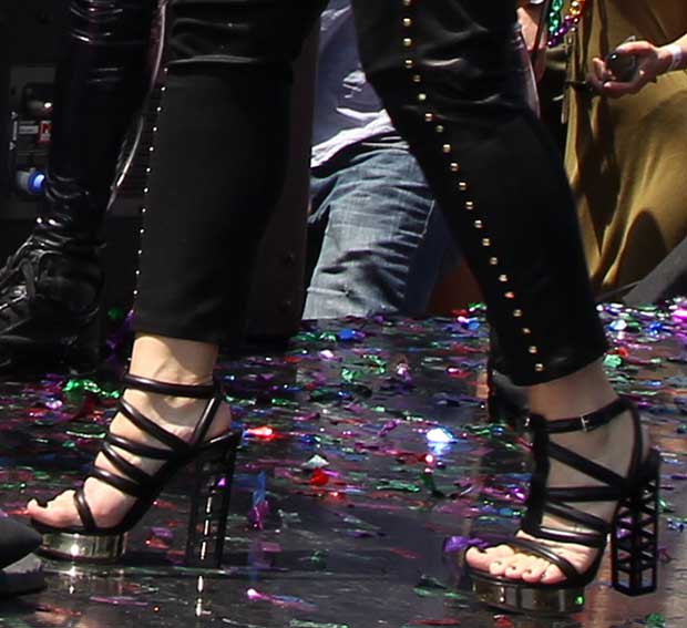 Demi Lovato paired her striking Gianmarco Lorenzi heels, featuring bold cage-like metallic details, with sleek studded pants