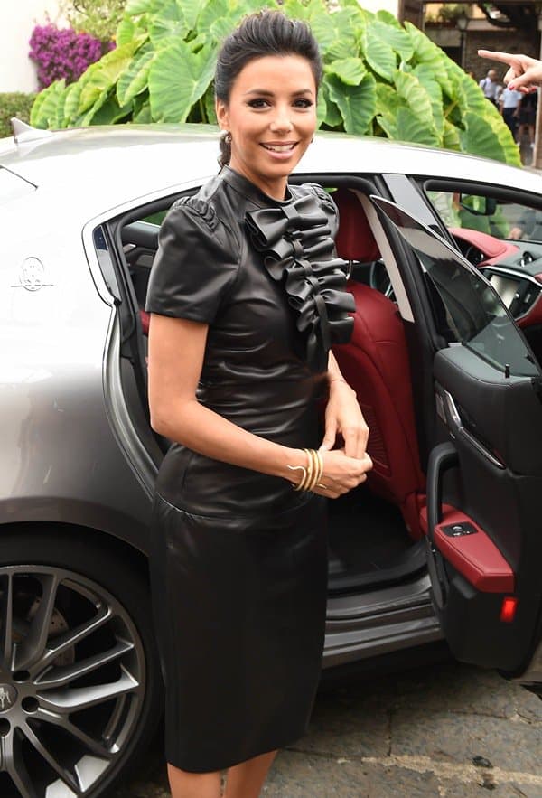 Eva Longoria steps out of a Maserati at the Taormina Film Festival, looking fierce in a Dsquared² leather dress with flirty bows on the bodice