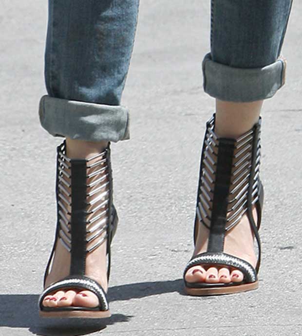 These statement-making sandals feature a bold caged design with metallic accents, complemented by slim straps and a modern stiletto heel, perfectly highlighting Gwen's edgy and chic style