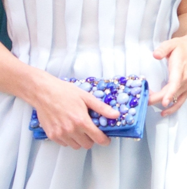 Keira Knightley's unique clutch is a stunning blue piece adorned with vibrant cabochons and rhinestones