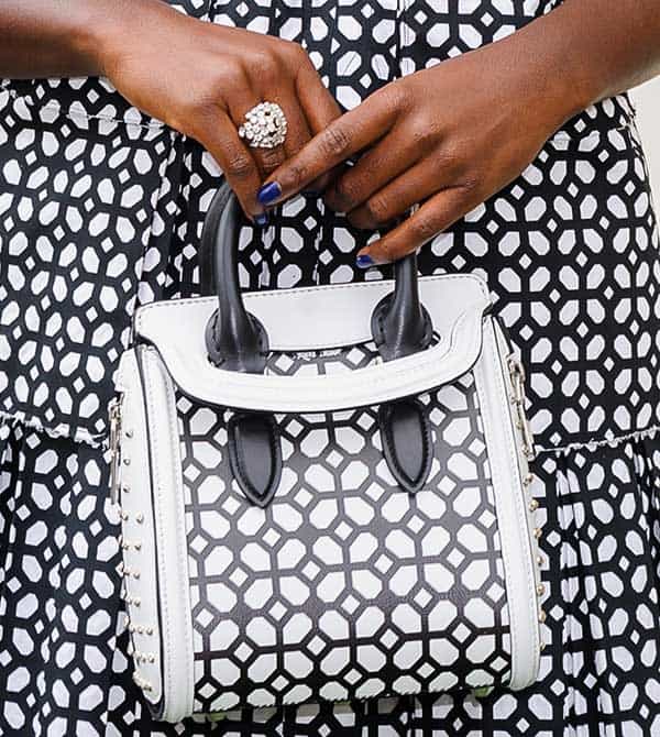 Lupita Nyong’o accessorizes her look with a geometric Alexander McQueen tote and a sparkling statement ring at the 7th Annual Veuve Clicquot Polo Classic