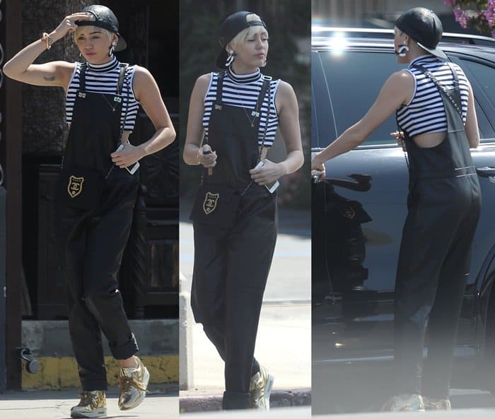 On June 25, 2014, in Studio City, Miley Cyrus was spotted wearing Elizabeth and James Lars leather overalls, Nike Air Max 1 SP Liquid Gold sneakers, a Chanel Quilted Crest bag, Chanel dangling earrings, and a Cartier Juste Un Clou extra-large bracelet