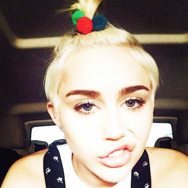 Miley Cyrus' punk-looking short blonde hair and colorful pompom band