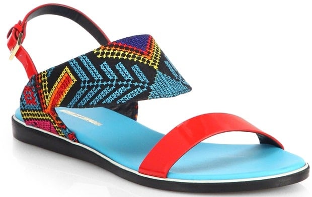 These vibrant sandals feature bold red straps, a colorful embroidered design, and a comfortable blue footbed