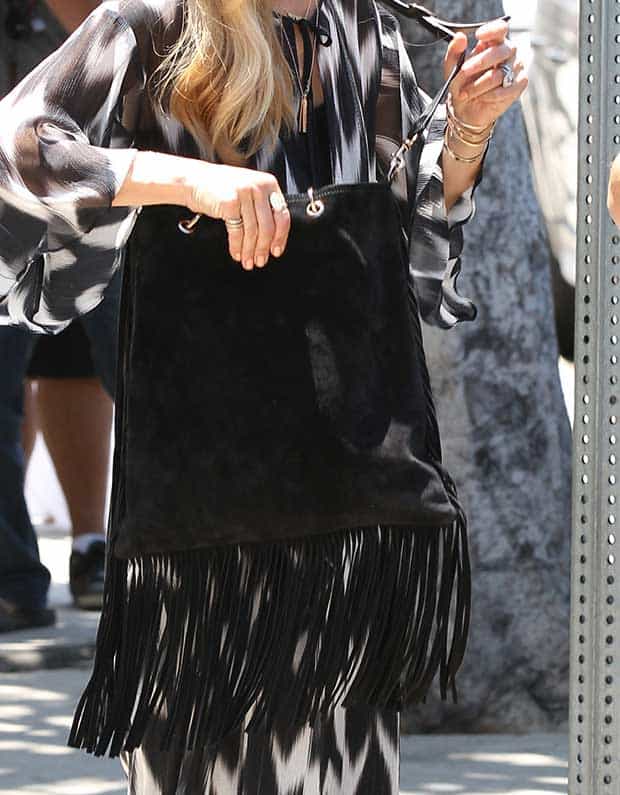 Rachel Zoe highlights her bohemian style with a black fringe Gucci shopper bag