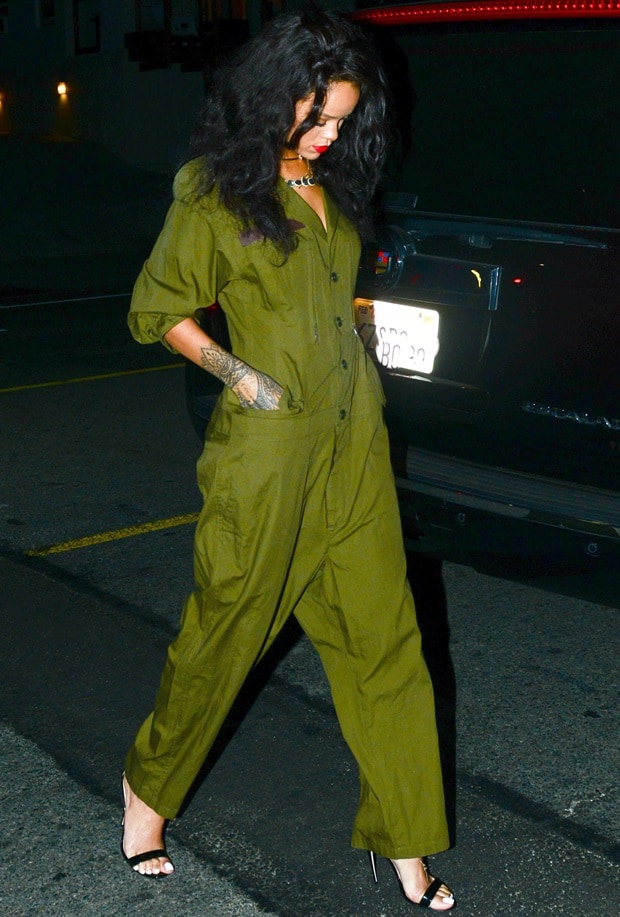 Rihanna rocks an effortlessly chic look in an olive-green jumpsuit paired with sleek black sandals