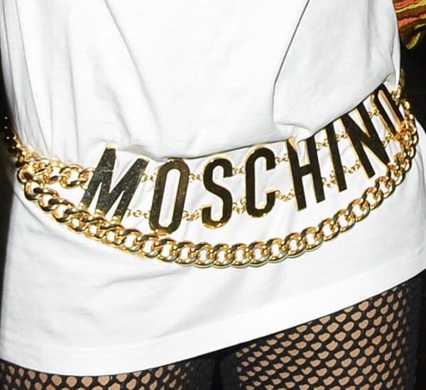 Rita Ora adds a bold touch to her outfit with a statement gold Moschino belt