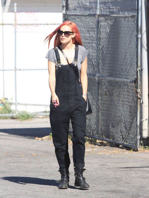 Rumer Willis rocks a pair of black dungarees with combat boots, effortlessly blending casual and edgy styles