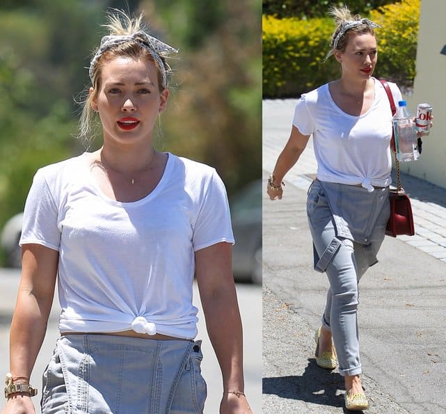 Hilary Duff sporting a charming scarf tied in a rockabilly style around her head paired with a red Chanel purse and Prada shoes