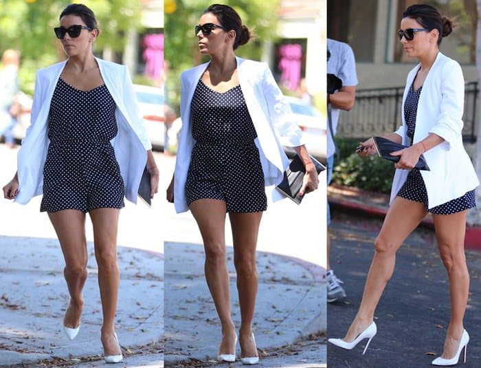 Eva Longoria wears a white blazer over a polka dot romper, paired with white pumps and sunglasses, creating a sleek and stylish look