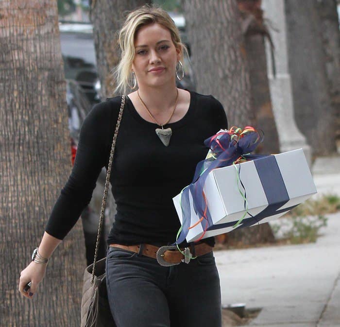 Hilary Duff stylishly dressed in a brown Western belt and carrying a gift in Studio City, spotted on July 19, 2014