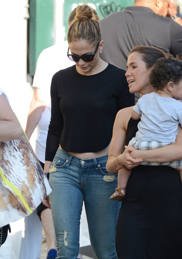 Jennifer Lopez steps out in Soho wearing a casual chic look, pairing distressed jeans with a black cropped top and oversized sunglasses