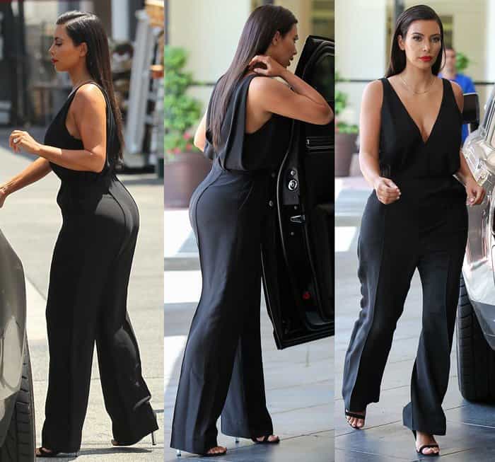 Kim Kardashian wears a sleek V-neck black jumpsuit with strappy heels, exuding minimalist elegance