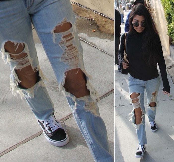 Kourtney Kardashian in distressed jeans and a black turtleneck paired with Vans ‘Old Skool’ sneakers