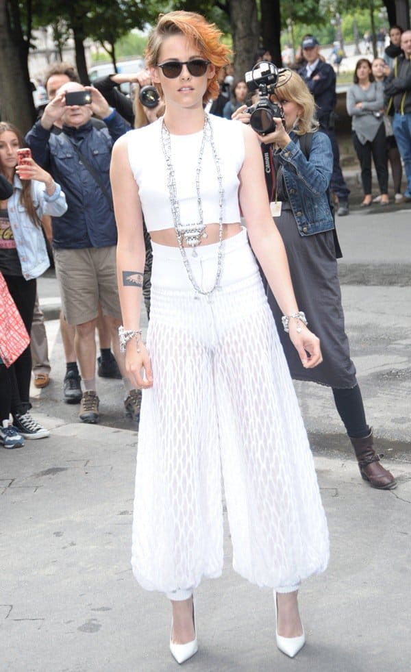 Kristen Stewart debuts her new short hairstyle and daring all-white ensemble at the Chanel Fall 2014 Couture show in Paris