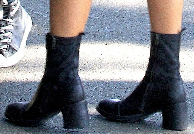Kylie Jenner's Ann Demeulemeester boots, featuring double zippers and chunky heels, perfectly complement her chic monochrome outfit