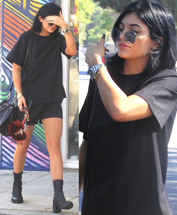 Kylie Jenner donned an Alexander Wang pinstriped tee and matching shorts styled with Rayban sunglasses and a pair of boots by Ann Demeulemeester