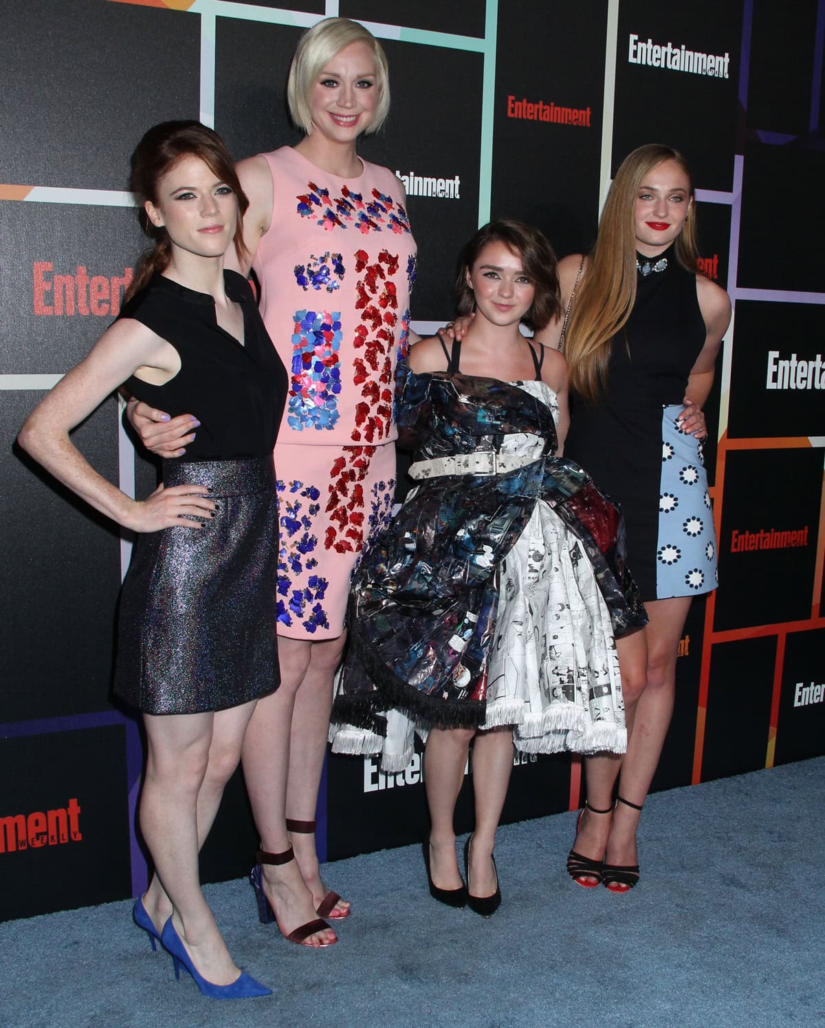 Maisie Williams, Sophie Turner, Gwendoline Christie, and Rose Leslie posed together at the event, each showcasing their own distinct style—from Maisie’s recycled comic-book dress and black velvet pumps to Sophie’s ankle-strap sandals, Gwendoline’s jewel-embellished shift with nude heels, and Rose’s metallic mini paired with bold blue pumps