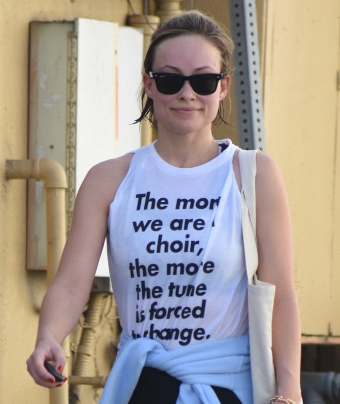 Olivia Wilde wearing a shirt featuring a quote from Amber Tamblyn's November 30 New York Times editorial: 'The more we are a choir, the more the tune is forced to change.'