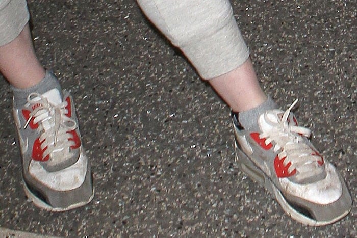 Rose Leslie completes her casual airport look with classic red and white Nike 'Air Max 90' sneakers
