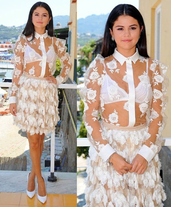 Selena Gomez wearing a Bluemarine outfit consisting of a sheer white shirt and a feather-embellished skirt