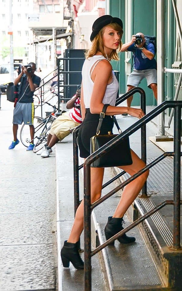 Taylor Swift accessorized her look with Rag & Bone Miles boots and a black Free People Patton pork pie hat