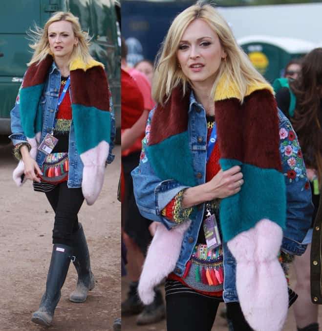 Fearne Cotton rocks a vibrant and eclectic layered look at the 2014 Glastonbury Festival, pairing an embroidered denim jacket with a colorful fur scarf and rain boots