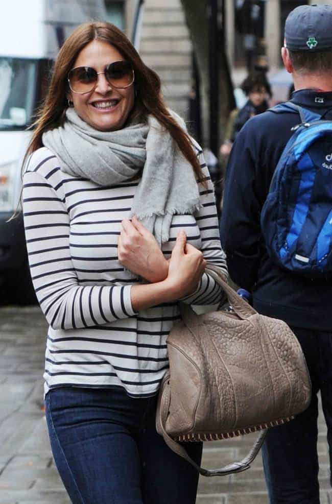 Lisa Snowdon bundles up in a scarf and shows off her Rocco duffel bag from Alexander Wang