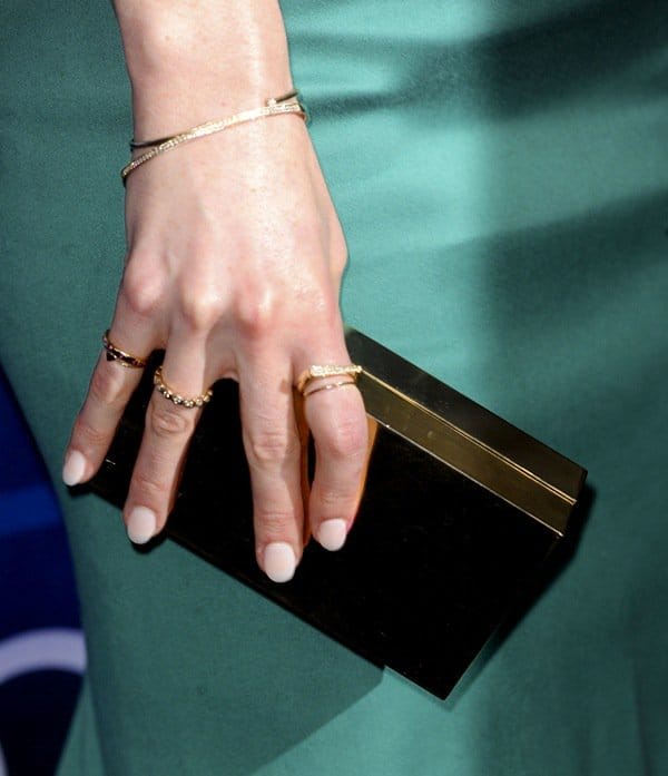 Michelle Dockery shows off her gold box clutch, Melinda Maria rings and Dana Rebecca Designs bracelets